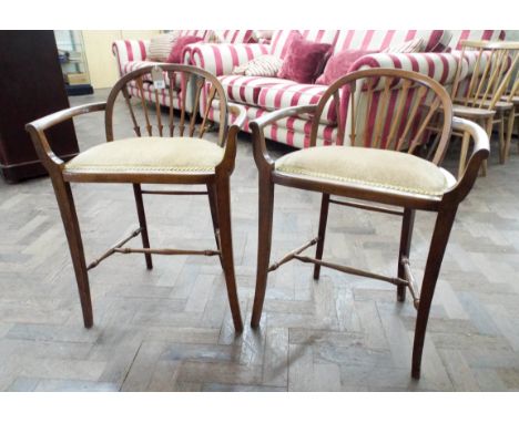 A pair of Edwardian comb back high seated occasional chairs or music stools upholstered in a gold brocade and corded fabric