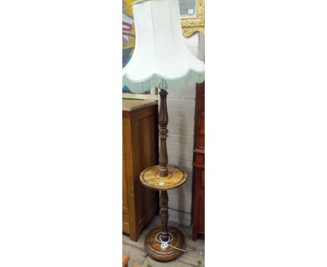 A 1930's oak standard lamp with green shade and attached coffee table tier 
