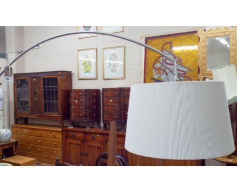 A contemporary chrome framed angle lamp standard with shade 