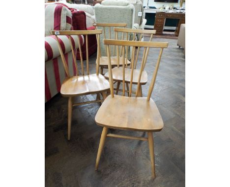 A set of four Ercol retro stick back dining chairs 