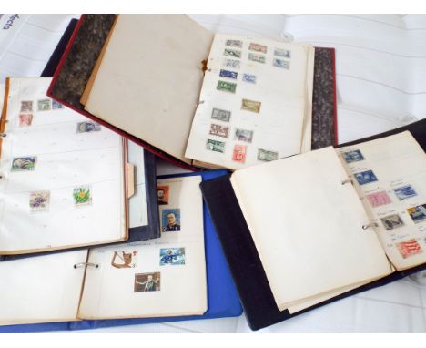 A shelf full of various stamp albums 