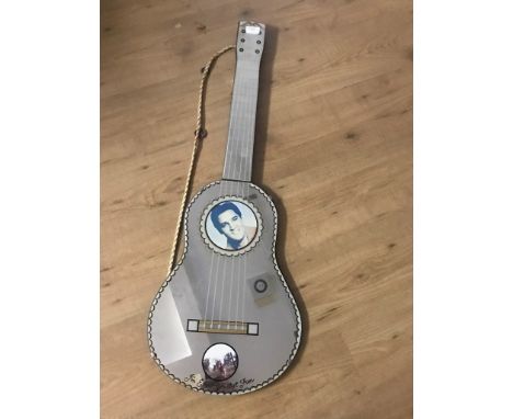 A 1960's Elvis Presley guitar-shaped mirror