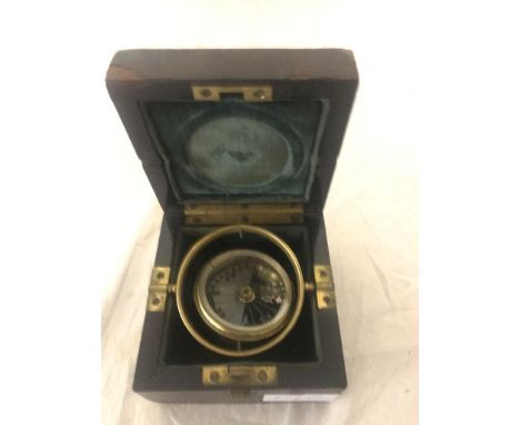 A boxed gimble-mounted compass in presentation box "Presented by Lieut Colonel Lambert Won by C W Hamerton with The Snark- Au