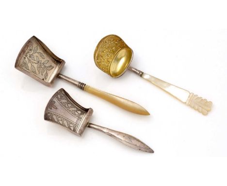 A George III silver caddy spoon, in the form of a scoop, with a hollow stem and an engraved bowl, by William Pugh, Birmingham