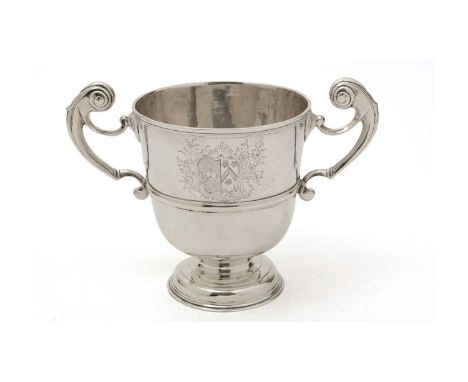 A George I Irish silver cup, with two harp-shaped handles, a domed circular pot and a campana-shaped bowl with a moulded gird