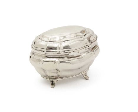 An Edwardian silver tea caddy of shaped oval outline and bombé form, resting on four curved feet, by the Goldsmiths and Silve