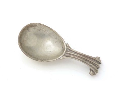 A George V silver hand-made caddy spoon, with an egg-shaped bowl, a reeded handle and a scroll terminal and a pronounced ratt