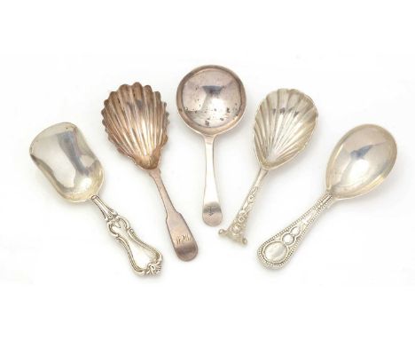 Three various Victorian silver caddy spoons, with patterned stems; an Irish silver fiddle pattern caddy spoon, with a fluted 