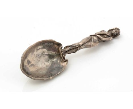 An Elizabeth II cast and sculpted silver caddy spoon, figural, in the form of a coy young girl in a clingy shoulderless dress