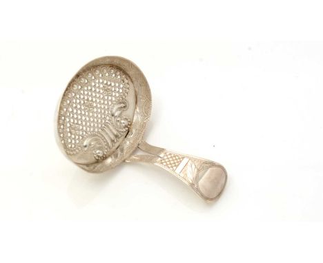 A George III silver caddy spoon,with an engraved, bifurcated stem and an oval bowl with a stamped and pierced reticulated des