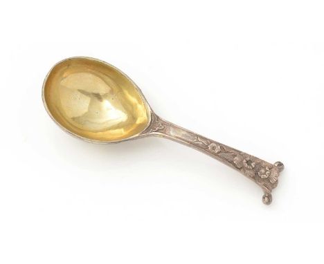 An early Victorian cast-silver caddy spoon, with a gilt, deep, egg-shaped bowl and a chased floral stem with a scroll termina