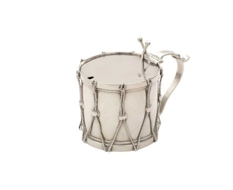 A Victorian silver novelty mustard pot, in the form of a drum, with corded wire tensioners, a strap handle and crossed drumst