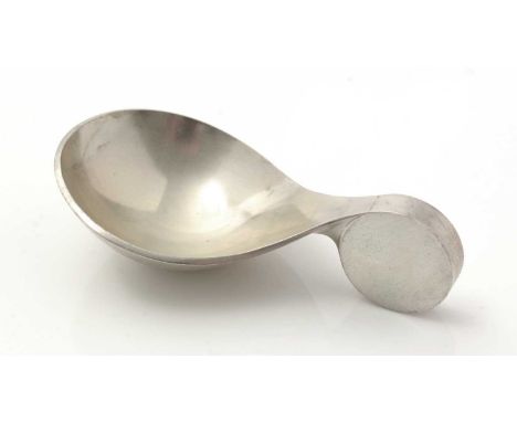 An Elizabeth II silver caddy spoon, by Garrard & Co., Ltd, designed by and signed "Des. A.G.Styles", London 1970, 6.8cm long,