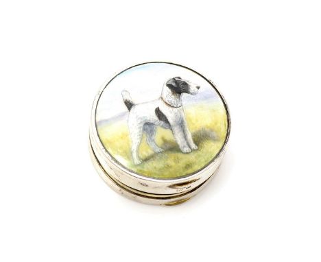 A George V small silver compact, circular with the enamelled figure of a fox terrier on the cover in polychrome, gilt interio