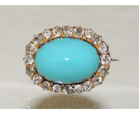 An 18ct gold (tested) oval turquoise brooch with a surround of diamonds in an openwork frame. 
