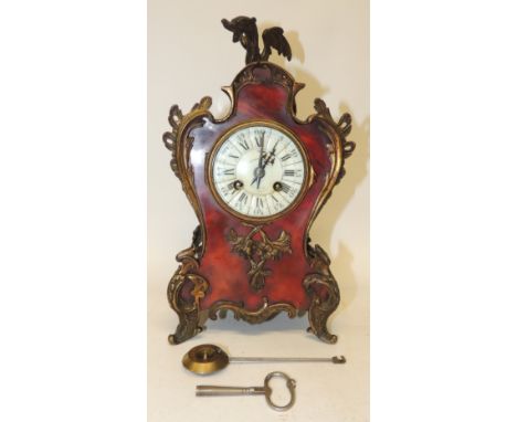 A late 19th Century French mantel clock by Mougin, having circular white enamel dial with black Arabic and Roman numerals, ho