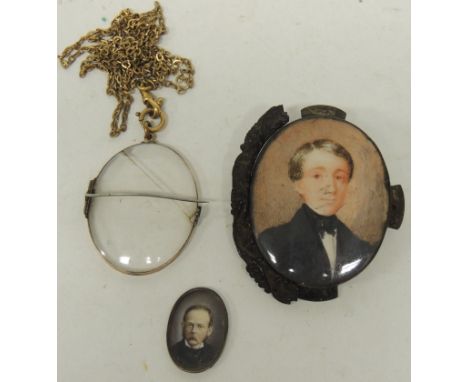 A small 19th Century miniature portrait of a gentleman on ivory, in metal mount, 3cms x 2.25cms; an oval miniature portrait o