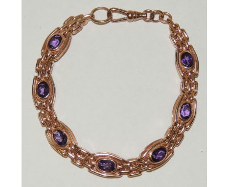 A 9ct Rose gold gate link/oval panel bracelet, the panels each set with an amethyst with swivel and link clasp.  17.3g approx