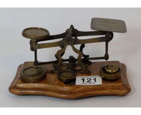 Edwardian brass and oak set of letter scales with 4 brass weights