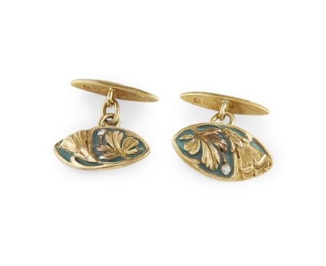A pair of Art Nouveau diamond and enamel cufflinks  each principal terminal with cast foliate detail and green enamel ground,