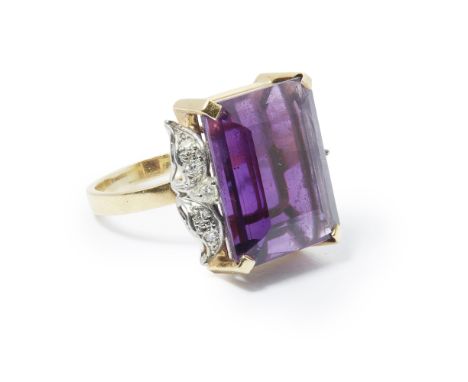 An amethyst set cocktail ring  claw set with a large rectangular cut amethyst, each shoulder set with a floral motif set with