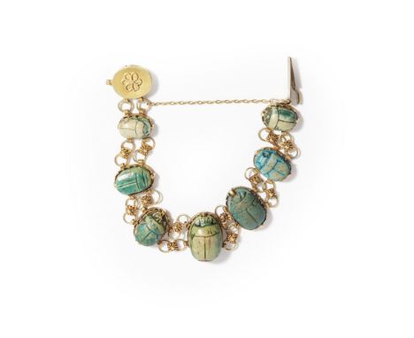 A scarab beetle bracelet  composed of seven graduated glazed ceramic scarab beetles with hieroglyphs to reverse, to floral li