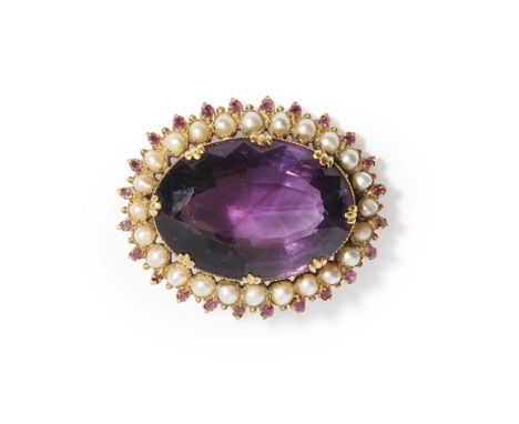 A large amethyst and pearl set brooch  claw set with a large oval mixed cut amethyst, in a border of half-pearls and small ro