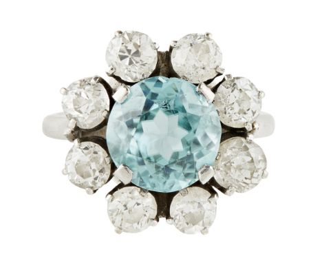 A zircon and diamond set cluster ring  claw set with a round cut blue zircon, in a border of old round cut diamonds, to a pla