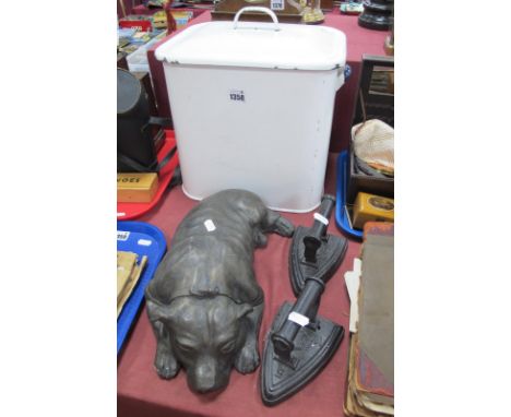 Concrete Door Stop as a Reclining Dog, 37cm long (damaged), two flat irons, enamelled bread bin. (4)