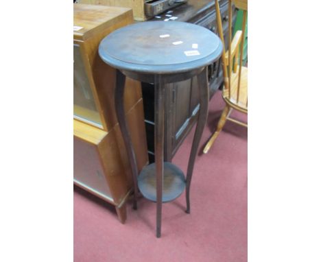 An 1920's Oak Plant Stand, having circular top and under shelf, united by sabre legs, 93cm high. 