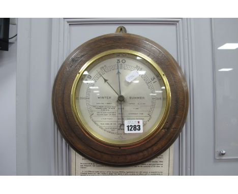 An Oak Circular Frame Wall Barometer, bearing anchor mark 27cm diameter.