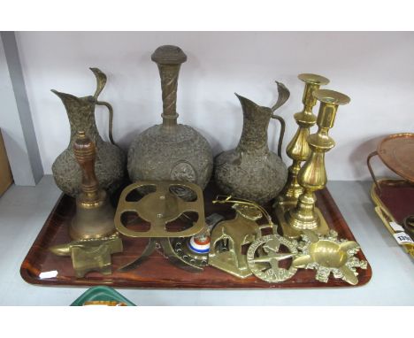 An Indian Brass Decanter, and pair of ewers, bell, candlestick, etc:- One Tray.