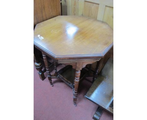 An Early XX Century Walnut Window Table, having octagonal top, square galleried under shelf, united by eight spindle legs, 60