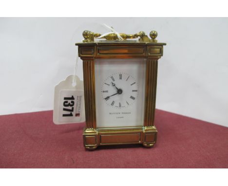 M. Norman of London Small Brass Cased Carriage Clock, having Swiss made movement, 9.2cm high, with handle down.
