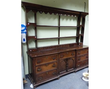 A 19th C. OAK DRESSER, THE THREE OPEN BACKED SHELVES TO THE BACK FLANKED BY THREE SMALLER SHELVES WITH OGEE ARCHED APRONS AND