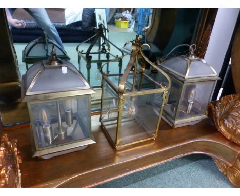 A PAIR AND ANOTHER GLAZED BRASS LANTERN, EACH OF SQUARE SECTION.   H 30 AND 40cms., A WALL LIGHT ON A BRASS ARM AND A FROSTED