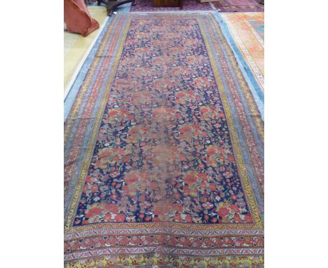 AN ANTIQUE PERSIAN COUNTRY HOUSE GALLERY CARPET. 455 x 207cms