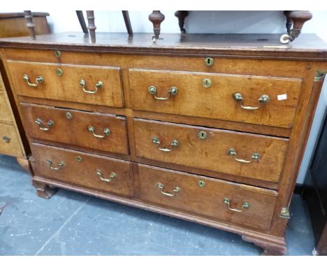 AN 18th  C. OAK MULE CHEST, THE COFFER TOP OVER TWO BANKS OF THREE DRAWER FRONTS, FOUR OF THE DRAWERS REAL AND ABOVE THE SHAP