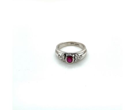 A 14ct WHITE GOLD HALLMARKED RUBY AND DIAMOND CONTEMPORARY RING. THE OVAL CUT RUBY IN A RUBOVER SETTING FLANKED BY SIX ROUND 