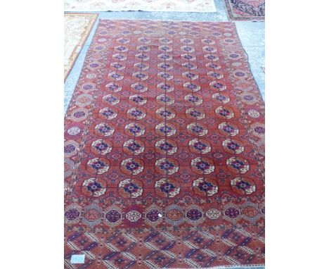 AN ANTIQUE TEKKE BOKHARA MAIN CARPET. 317 x 209cms