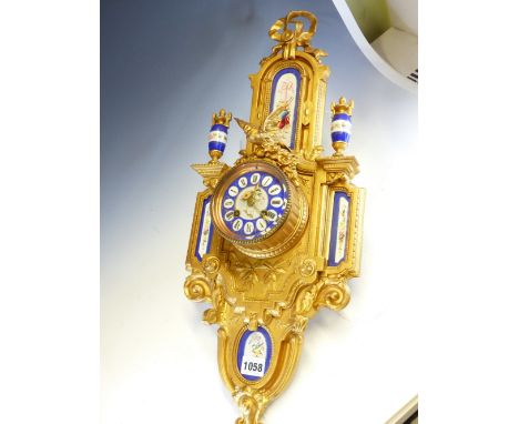 A LATE 19th C. FRENCH GILT SPELTER AND BLUE GROUND PORCELAIN WALL CLOCK, THE JAPY FRERES MOVEMENT STRIKING ON A BELL, THE POR