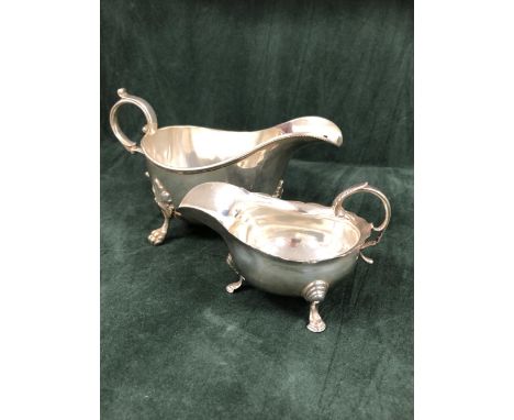 A SILVER TRIPOD SAUCE BOAT BY HENRY WILKINSON &amp; Co., LONDON 1905, ITS RIM BEADED TOGETHER WITH ANOTHER TRIPOD SAUCE BOAT,