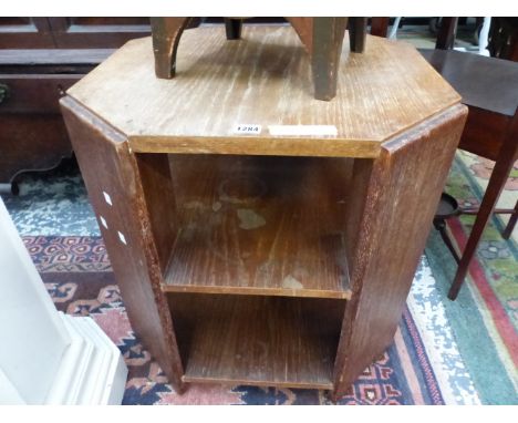 AN ART DECO OAK COFFEE TABLE, THE CANTED PANEL CORNERS SUPPORTING TWO TIERS OF SHELVES.&nbsp; &nbsp;W 56 x D 56 x H 58.5cms.