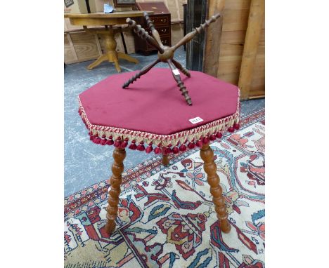 A BLOND WOOD GYPSY TABLE WITH RED CLOTH COVERED OCTAGONAL TOP AND THREE BOBBIN TURNED LEGS. W 52 x D 51 x H 62cms. TOGETHER W