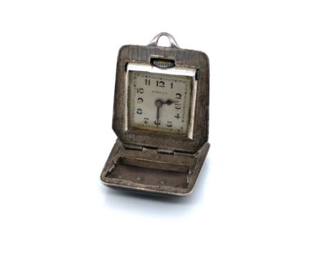 ETERNA CIRCA 1930'S TRAVEL FOB WATCH / CLOCK. STAMPED TO INSIDE REVERSE BREVET, DEM. 3011580. UNHALLMARKED, CASED ASSESSED AS