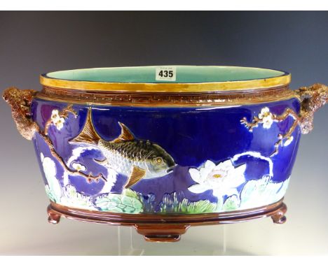 A 19th C. HOLDCROFT MAJOLICA OVAL PLANTER, THE BLUE EXTERIOR WITH FISH AND WATER LILIES IN RELIEF, THE RUSTIC HANDLES SPROUTI