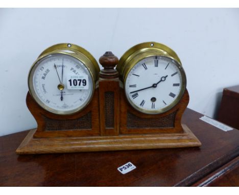 AN EARLY 20th CENTURY DESK CLOCK AND BAROMETER PAIR WITH CARVED OAK SUPPORT. EACH DIAL OF THE JOINED PAIR SIGNED COX.