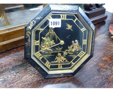 AN OCTAGONAL CHINOISERIE DECORATED DESK CLOCK WITH EASEL BACK