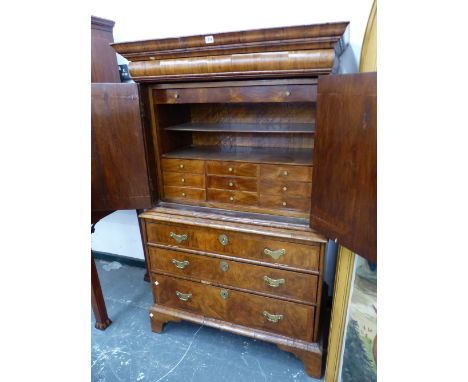 A GEORGIAN AND LATER&nbsp; WALNUT CABINET ON CHEST, AN OVOLU FRONTED DRAWER ABOVE THE DOORS TO THE TOP, THE BASE WITH THREE G