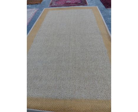 A CONTEMPORARY NATURAL FIBER WOVEN CARPET. 495 x 290cms